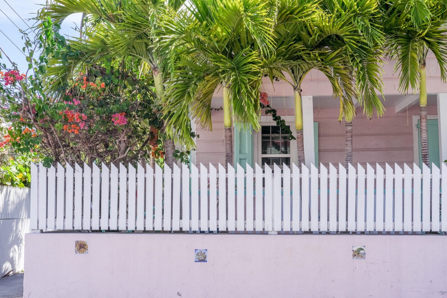 pink house with a picket fence