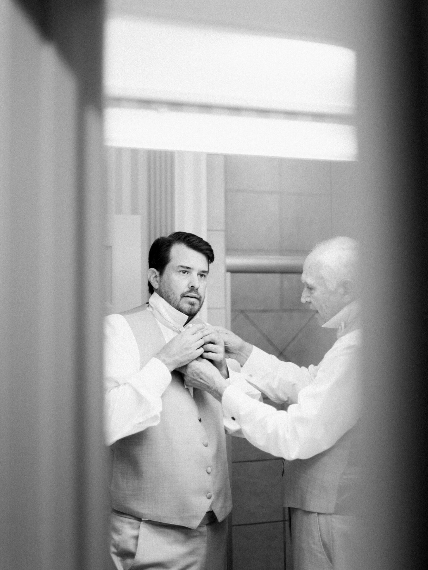 a groom getting ready with his father