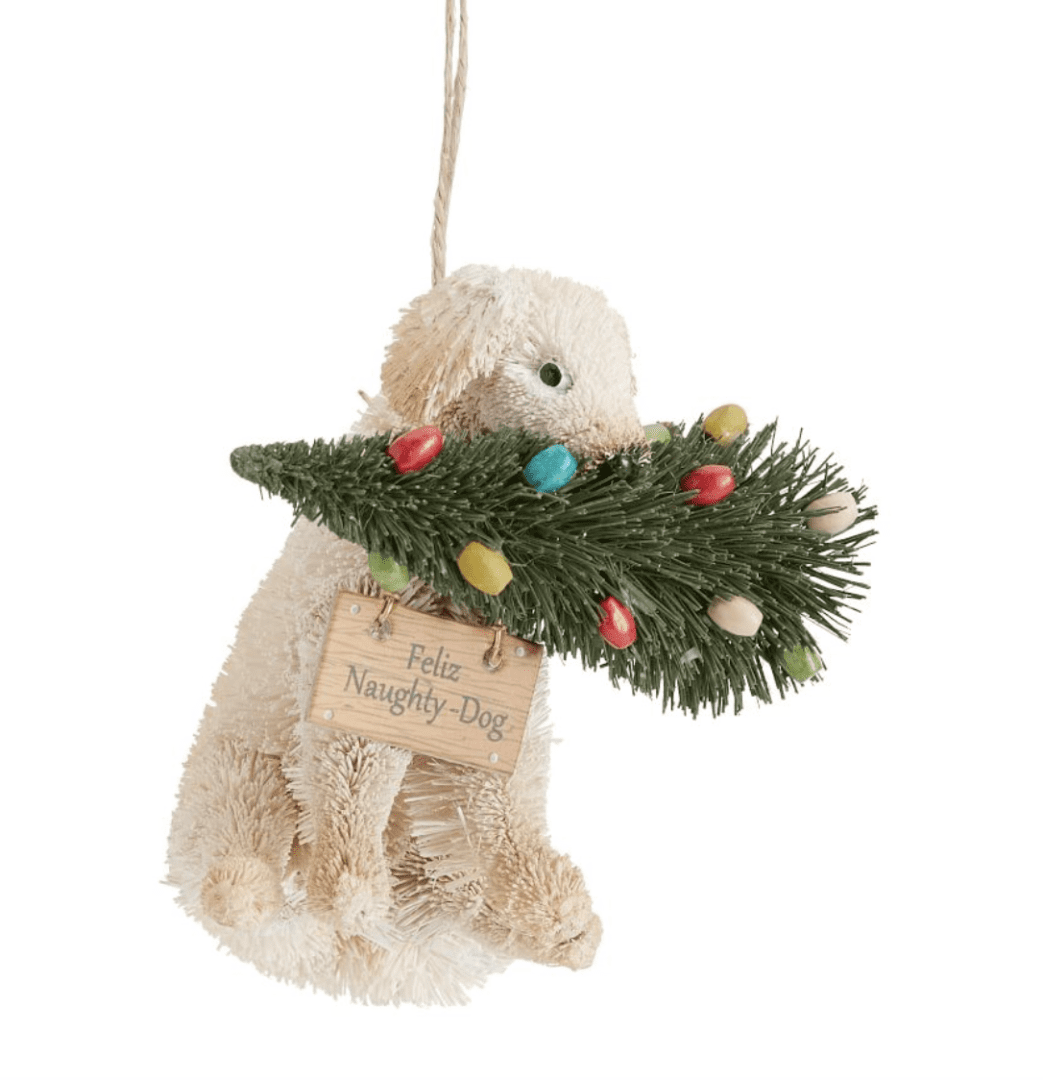 dog biting a Christmas tree ornament